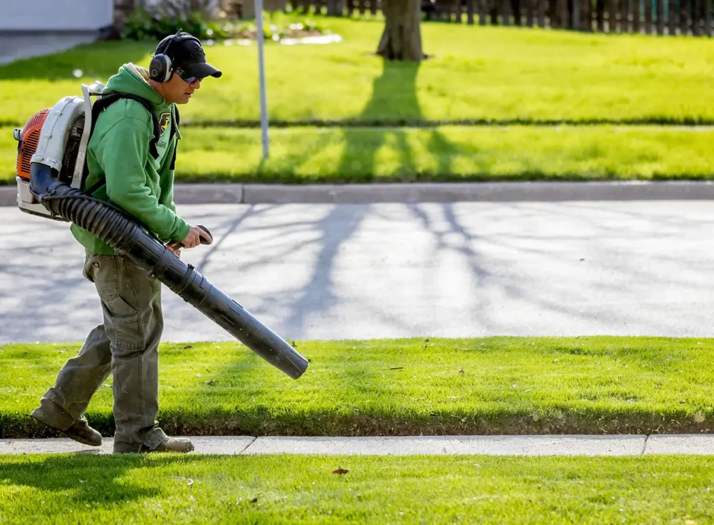 lawn maintenance professional using a leaf blower to clean the yard bloomington illinois
